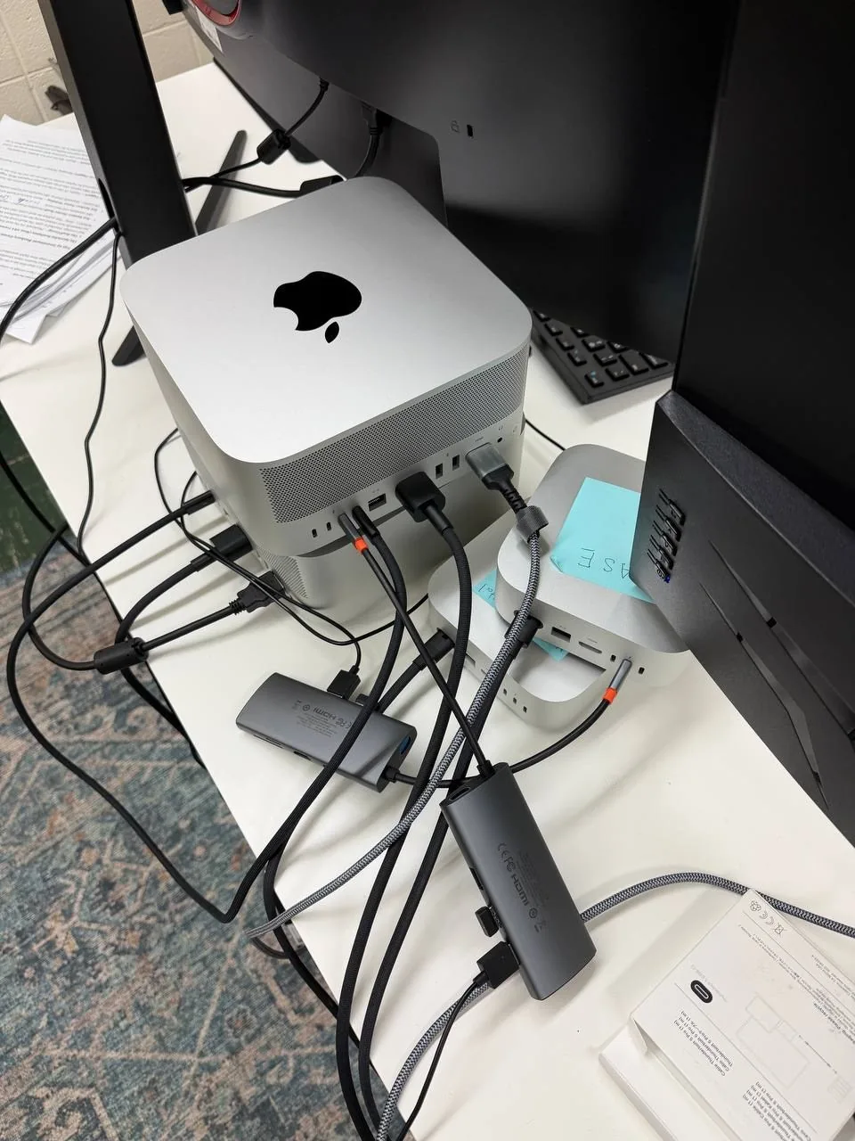 A Mac Studio with docks and cables, set up in an office to run a local AI model on premise
