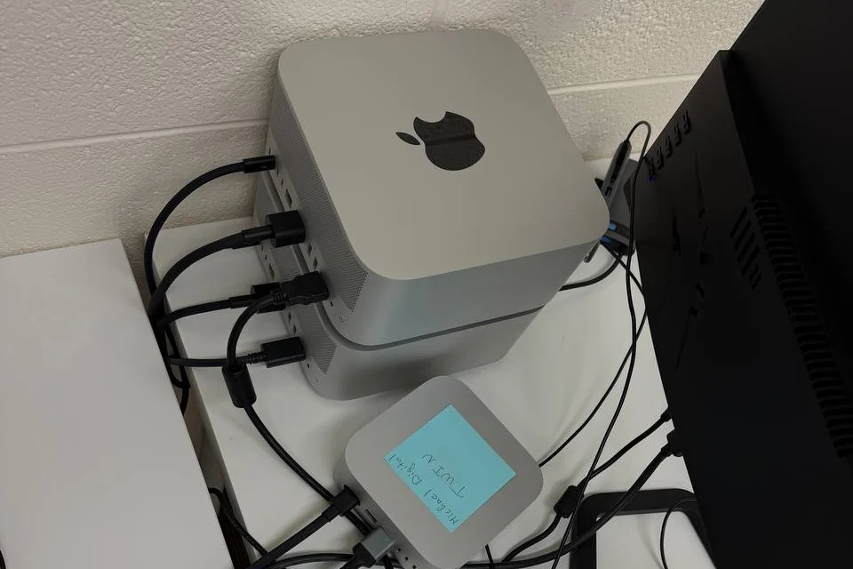 Two Mac Studios wired together at Bace Agency to run local AI models